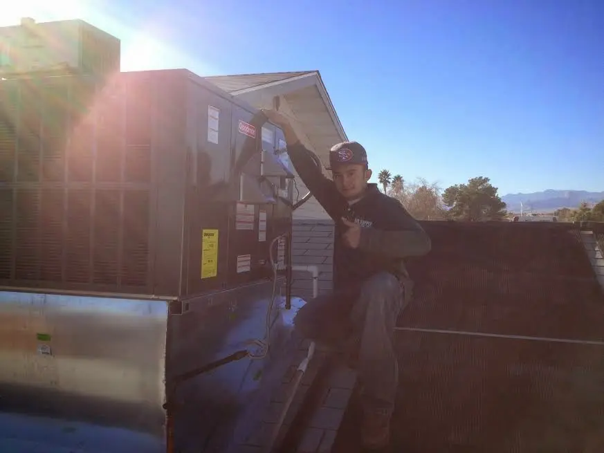 HVAC technician performing AC Tune-Up on a rooftop unit in Tualatin